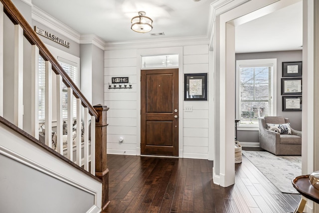 foyer featuring crown molding and dark wood-type flooring