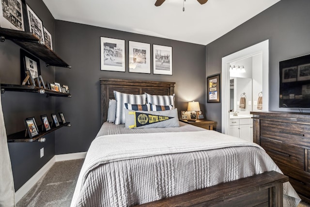 carpeted bedroom with ceiling fan, ensuite bathroom, and sink