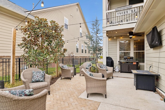 view of patio featuring a balcony, an outdoor hangout area, and ceiling fan