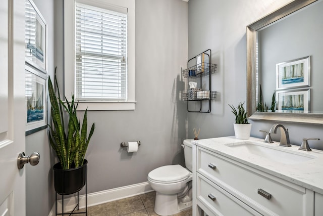 bathroom with vanity, tile patterned floors, and toilet