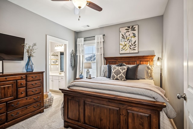 carpeted bedroom with ceiling fan, connected bathroom, and sink