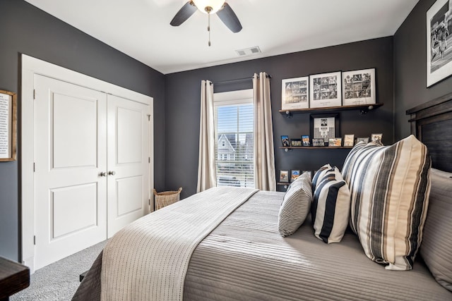 bedroom with ceiling fan, carpet floors, and a closet