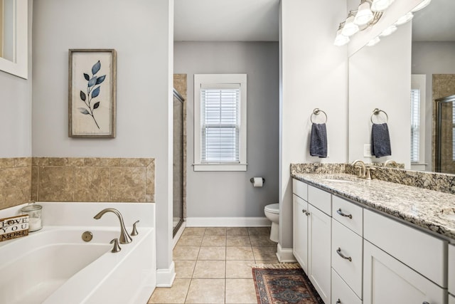 full bathroom with tile patterned flooring, vanity, shower with separate bathtub, and toilet