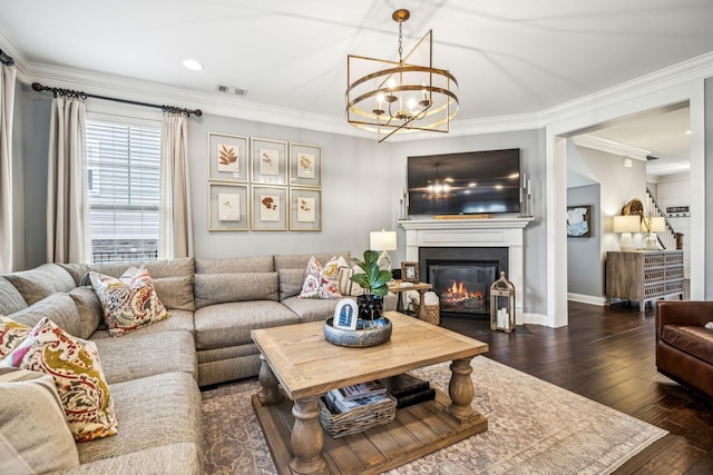 living room featuring crown molding, dark wood-type flooring, and a notable chandelier