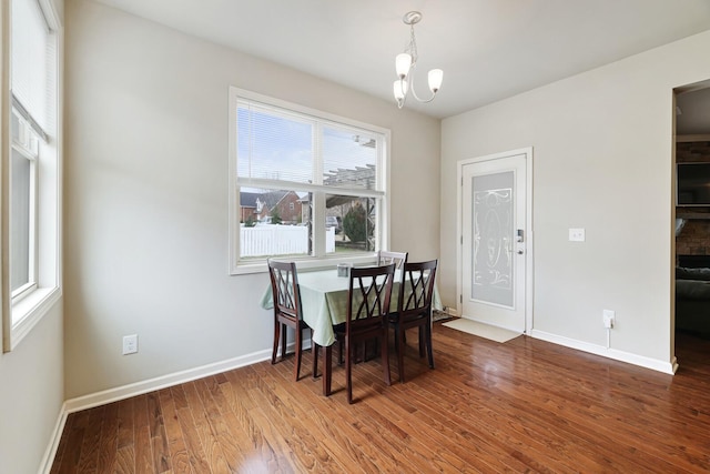 dining room featuring hardwood / wood-style floors and a notable chandelier