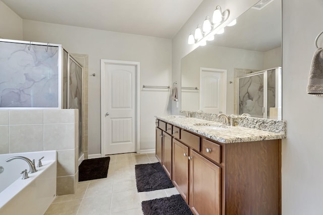 bathroom featuring vanity, tile patterned flooring, and shower with separate bathtub