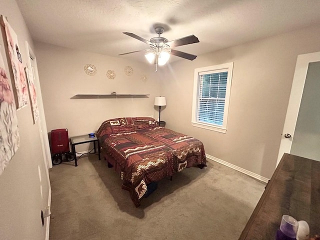 carpeted bedroom with a textured ceiling and ceiling fan