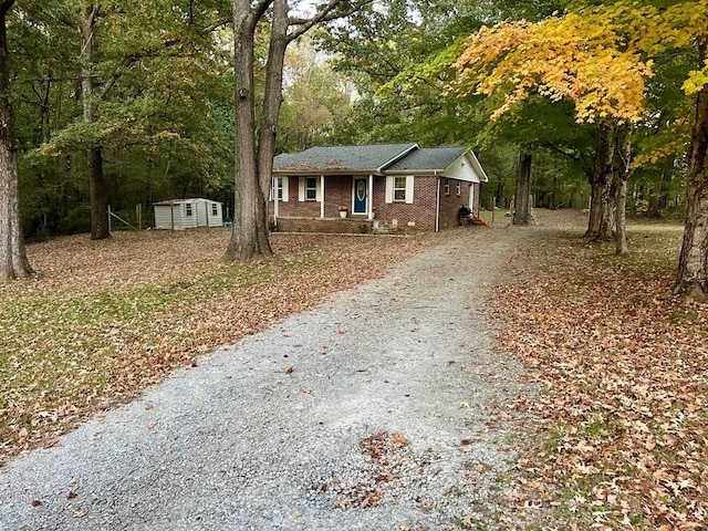 ranch-style house featuring a shed