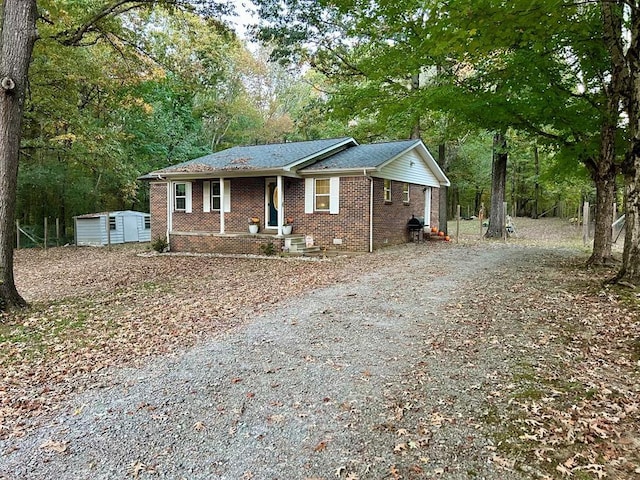 view of front of property featuring a storage shed