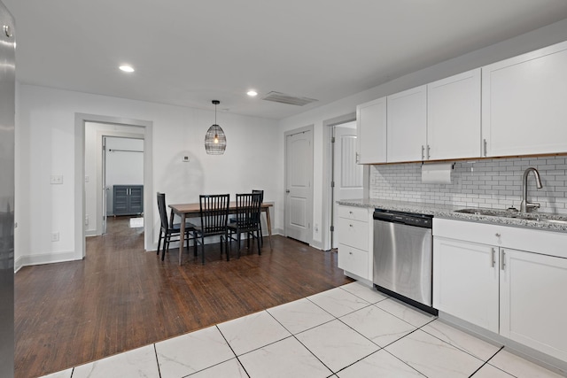 kitchen featuring sink, stainless steel dishwasher, white cabinets, and light stone counters