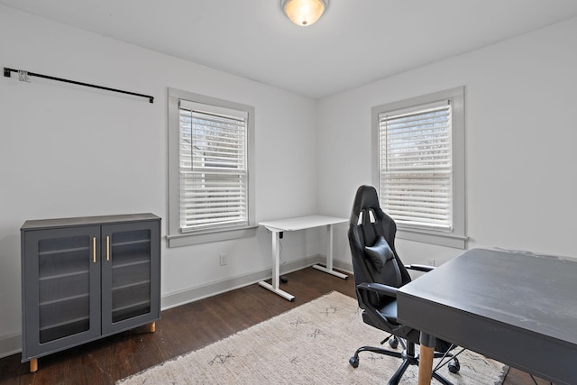 office with plenty of natural light and dark hardwood / wood-style flooring