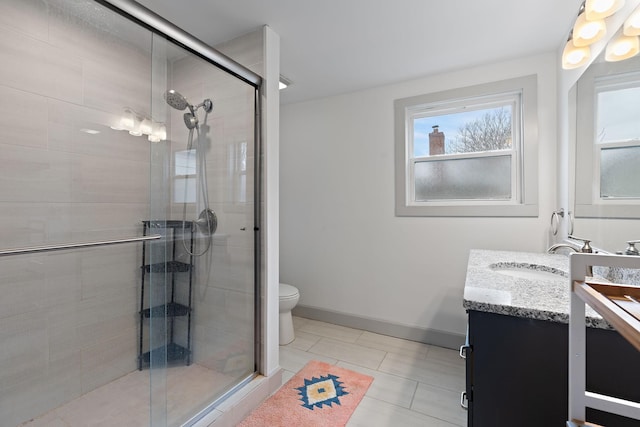 bathroom featuring vanity, an enclosed shower, tile patterned floors, and toilet