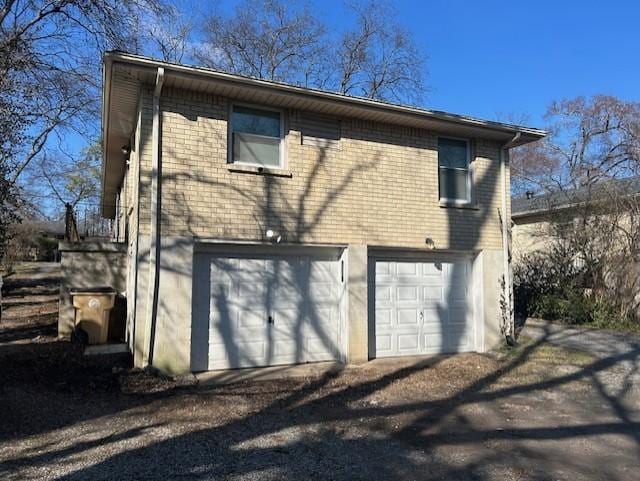 back of property with a garage