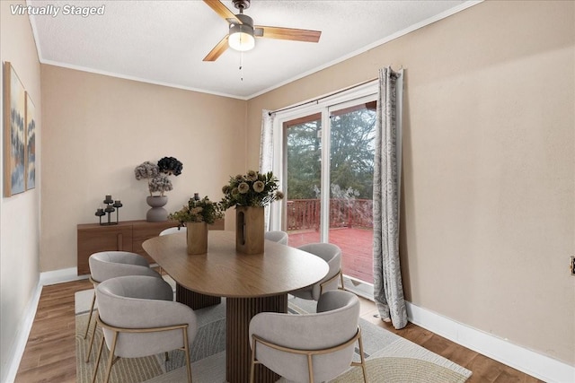 dining area with hardwood / wood-style flooring, ceiling fan, crown molding, and a textured ceiling