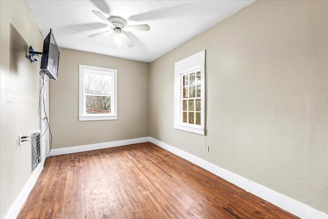 spare room featuring hardwood / wood-style floors, a textured ceiling, and ceiling fan