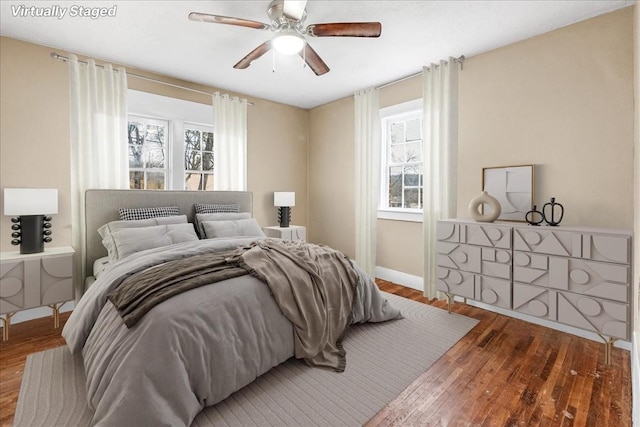 bedroom with wood-type flooring and ceiling fan