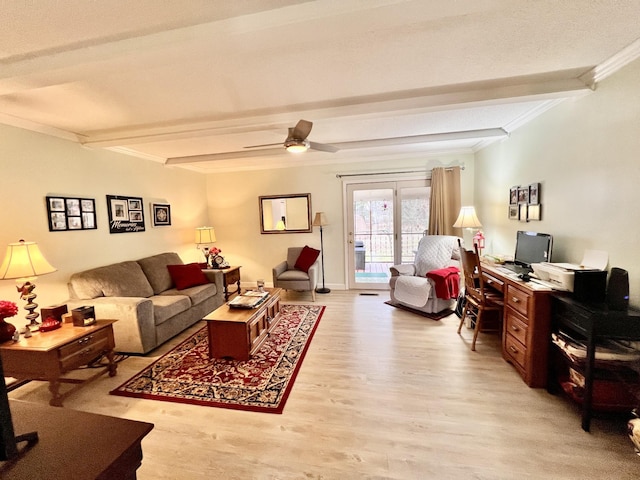 living room with ceiling fan, ornamental molding, light hardwood / wood-style floors, and beamed ceiling