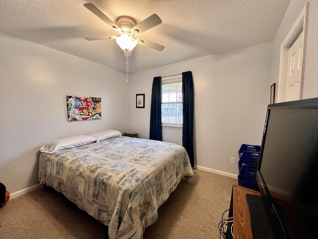 carpeted bedroom with ceiling fan and a textured ceiling