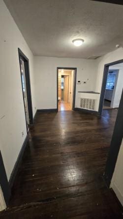 corridor featuring dark hardwood / wood-style flooring