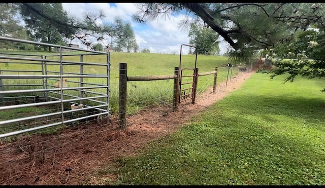 view of gate with a rural view