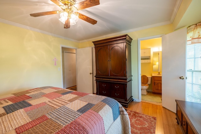 bedroom featuring connected bathroom, sink, ceiling fan, crown molding, and light wood-type flooring