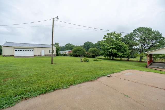 view of yard featuring a garage and an outdoor structure