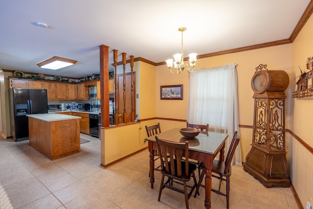 kitchen with crown molding, an inviting chandelier, hanging light fixtures, black appliances, and light tile patterned flooring