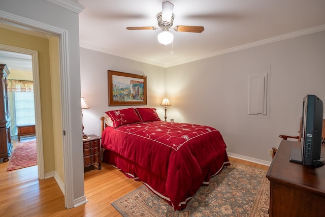 bedroom featuring wood-type flooring, ornamental molding, and ceiling fan