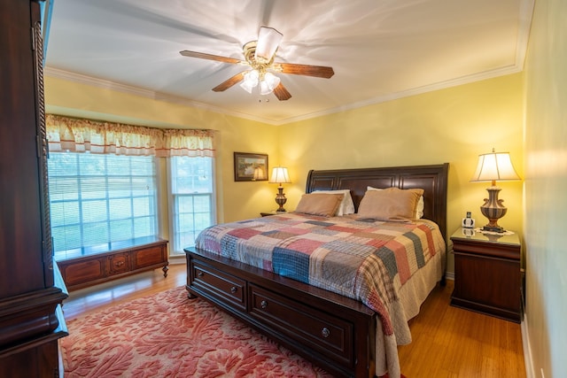 bedroom with light hardwood / wood-style flooring, ornamental molding, and ceiling fan