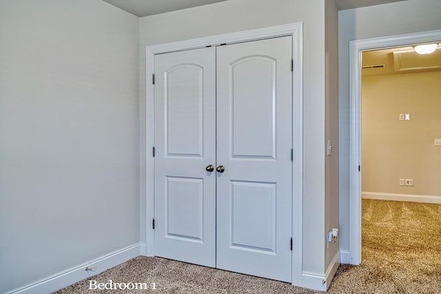 interior space featuring light carpet and a closet