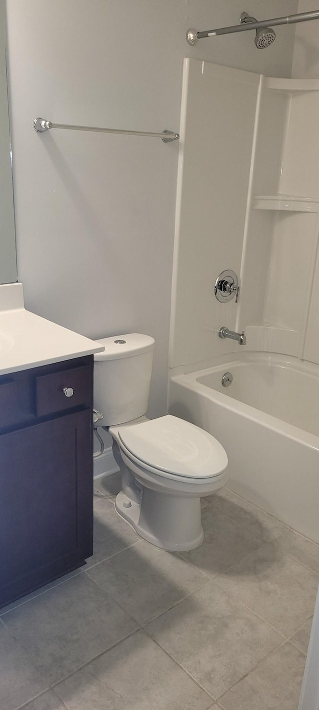 full bathroom featuring vanity, tile patterned floors, tub / shower combination, and toilet