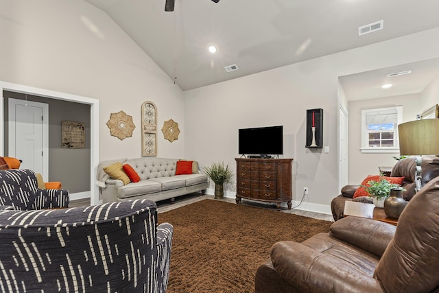 living room with hardwood / wood-style floors and high vaulted ceiling