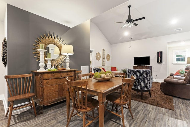 dining room featuring ceiling fan, lofted ceiling, and dark hardwood / wood-style flooring