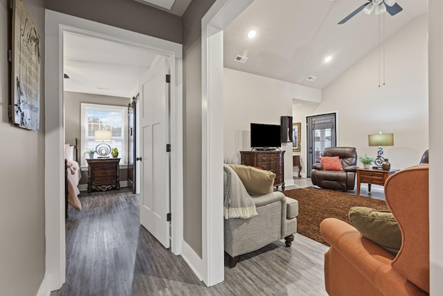 living room with high vaulted ceiling, dark hardwood / wood-style floors, and ceiling fan