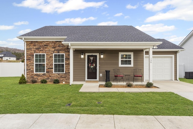 view of front of property with a garage, covered porch, and a front yard