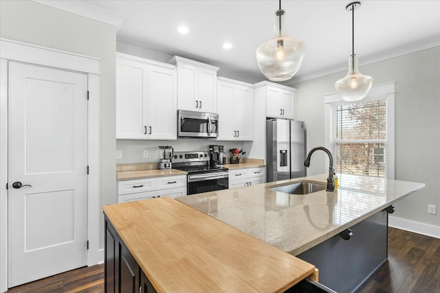 kitchen with pendant lighting, light stone countertops, stainless steel appliances, and a center island with sink