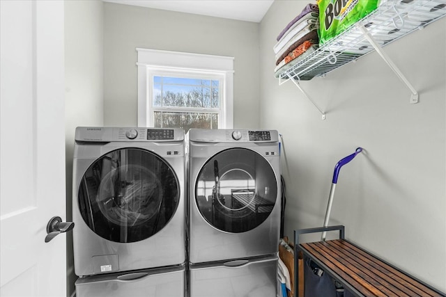 clothes washing area with washing machine and dryer