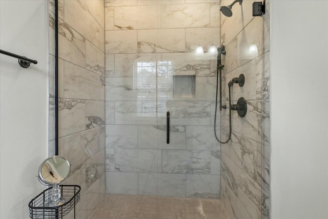 bathroom featuring a shower with shower door