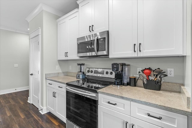 kitchen with stainless steel appliances, white cabinetry, dark hardwood / wood-style floors, and crown molding