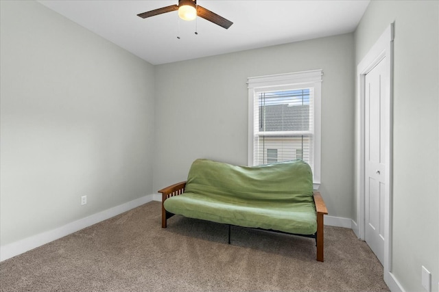 living area featuring ceiling fan and carpet flooring