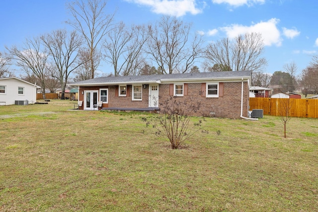 view of front of home with cooling unit, a front lawn, and french doors