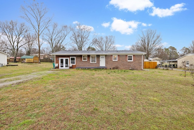 ranch-style home with french doors and a front yard