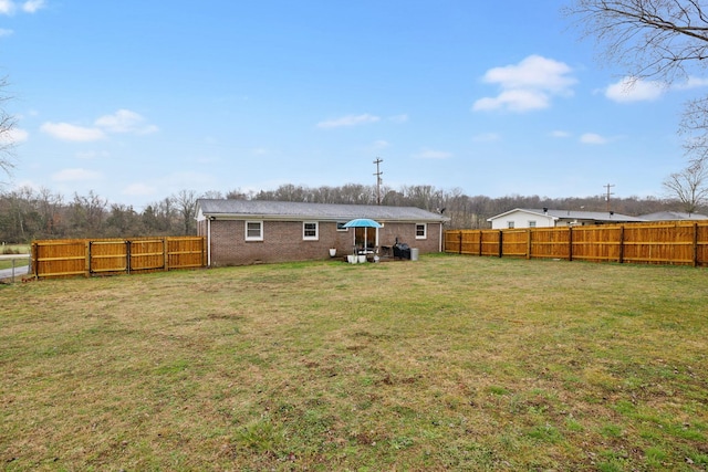 rear view of house featuring a lawn