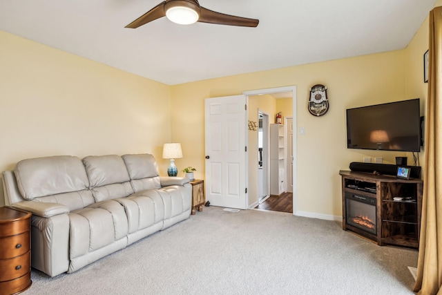 carpeted living room with ceiling fan