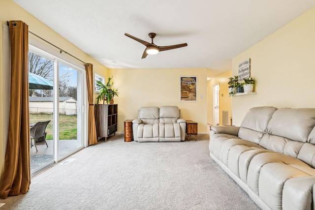 carpeted living room featuring ceiling fan