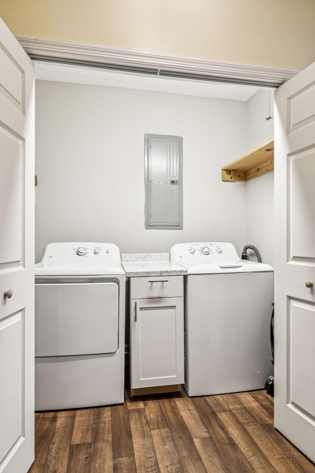 laundry room with cabinets, washing machine and dryer, dark hardwood / wood-style floors, and electric panel