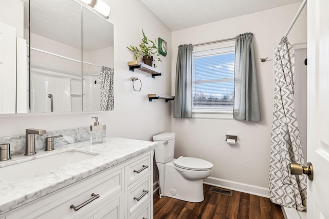 bathroom with hardwood / wood-style flooring, vanity, and toilet