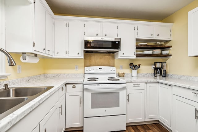 kitchen with dark wood-type flooring, white electric range oven, sink, and white cabinets