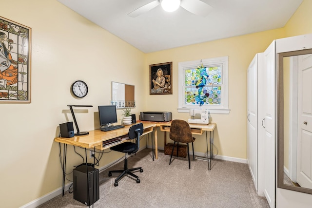 carpeted office space with ceiling fan