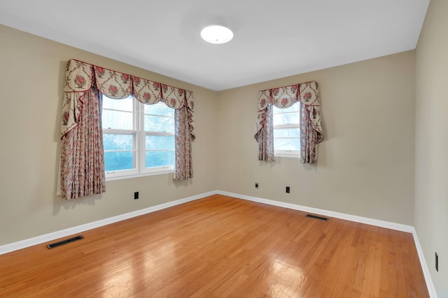 unfurnished room featuring hardwood / wood-style floors